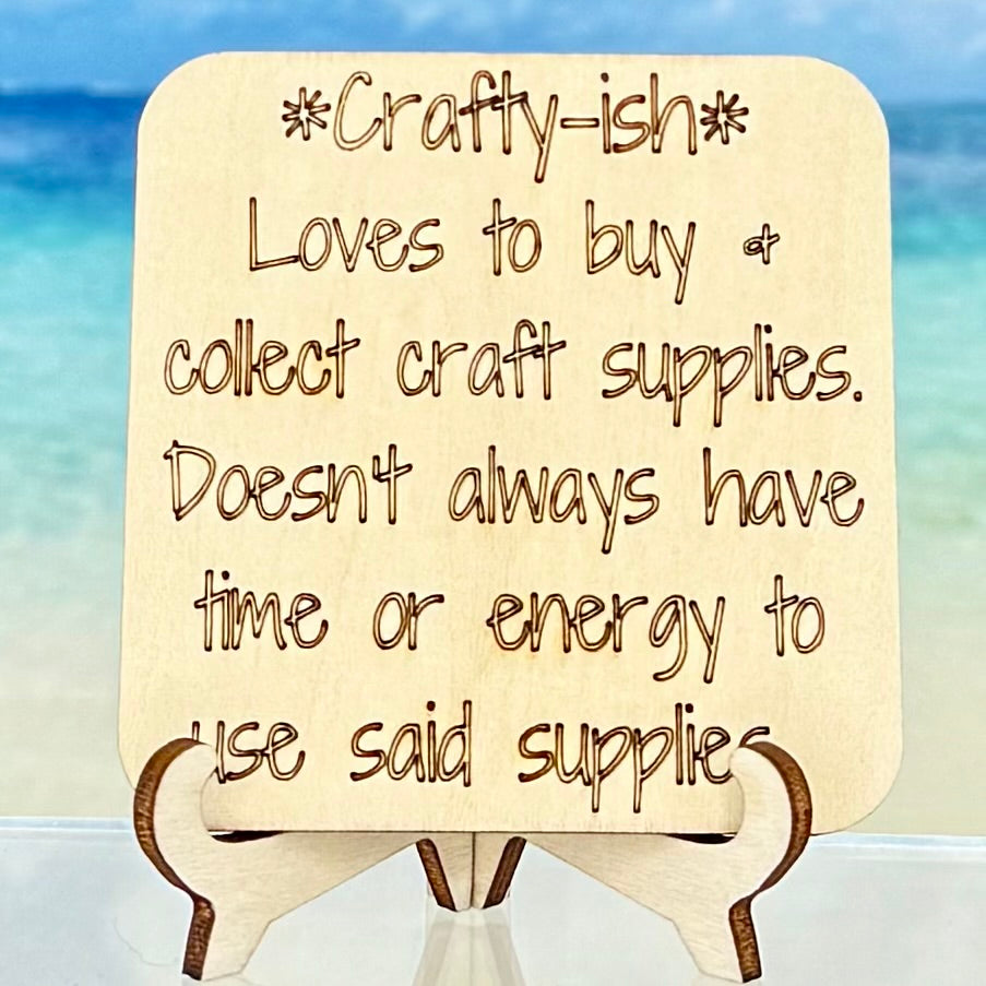Laser-cut wooden fridge magnet engraved with the quote ‘Crafty-ish: loves to buy and collect craft supplies, doesn’t always have time or energy to use said supplies.’ — handcrafted, humorous décor for makers and crafters.