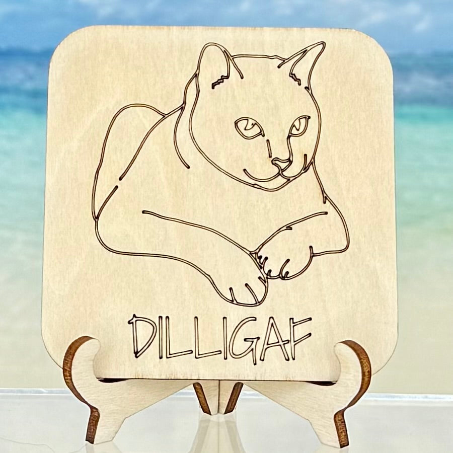 Laser-cut wooden fridge magnet engraved with ‘DILLIGAF (Do I Look Like I Give A F…?)’, featuring a cat design — handcrafted décor piece with strong magnet backing for cat lovers and sarcasm fans.