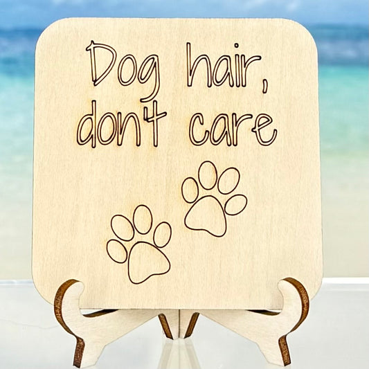 Laser-cut wooden fridge magnet engraved with the quote ‘Dog hair, don’t care’ and a paw print symbol — handcrafted décor gift for dog lovers with strong magnet backing.