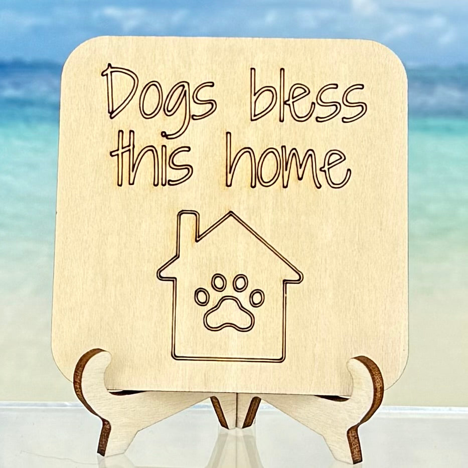Laser-cut wooden fridge magnet engraved with the quote ‘Dogs Bless This Home’ with a dog-house icon — handcrafted décor gift for dog lovers.