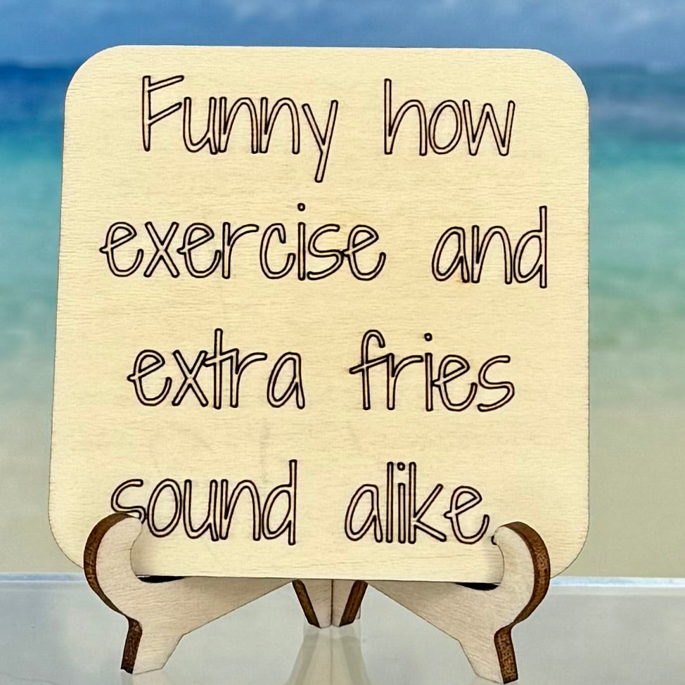 Laser-cut wooden fridge magnet engraved with the quote ‘Funny how exercise and extra fries sound alike…’ — handcrafted humorous décor with strong magnet backing, perfect for kitchen or fitness-lovers.