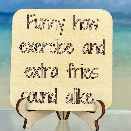 Laser-cut wooden fridge magnet engraved with the quote ‘Funny how exercise and extra fries sound alike…’ — handcrafted humorous décor with strong magnet backing, perfect for kitchen or fitness-lovers.