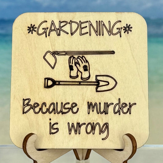 Laser-cut wooden fridge magnet engraved with the quote ‘Gardening because murder is wrong’ along with garden tool icons — handcrafted décor perfect for gardeners with a cheeky sense of humor.