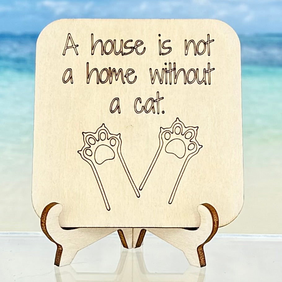 Laser-cut wooden fridge magnet engraved with the quote ‘A House Is Not A Home Without a Cat’ paired with a cat paw symbol — handcrafted gift for cat lovers.
