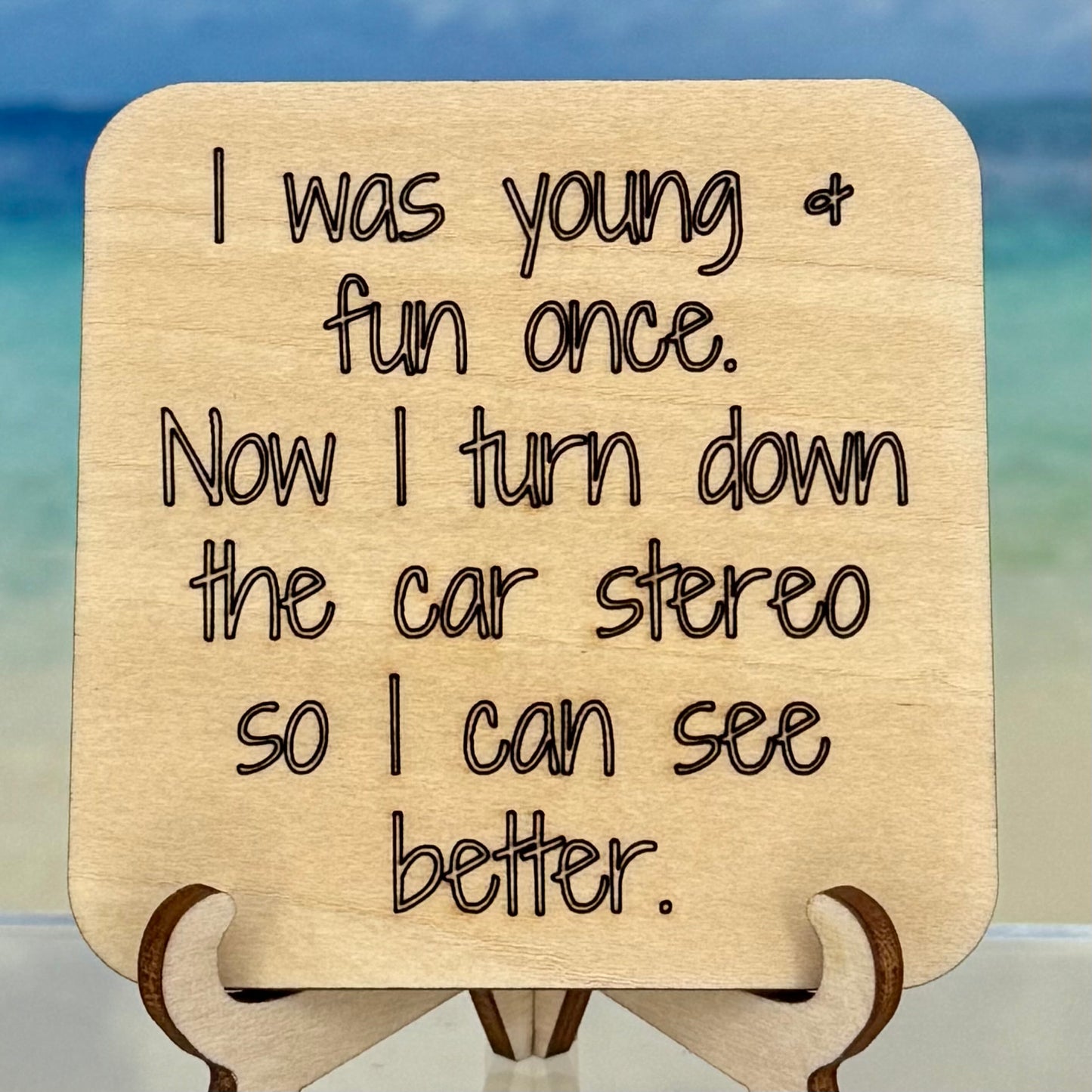 Laser-cut wooden fridge magnet engraved with the quote ‘I was young & fun once. Now I turn down the car stereo so I can see better.’ — handcrafted décor piece with strong magnet backing, perfect for a humor-filled gift.