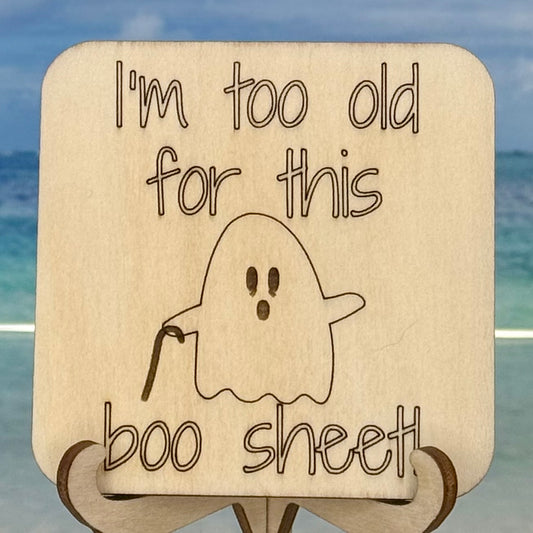 Laser-cut wooden fridge magnet engraved with the quote ‘I’m Too Old For This Boo Sheet’ and featuring an old ghost holding a cane — handcrafted humorous décor piece for Halloween or daily laugh.