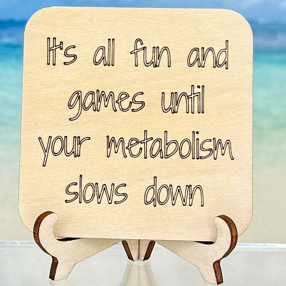 Laser-cut wooden fridge magnet engraved with the quote ‘It’s all fun and games until your metabolism slows down’ — handcrafted humorous kitchen décor with strong magnet backing.