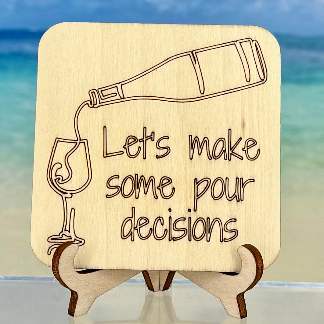 Laser-cut wooden fridge magnet engraved with the quote ‘Let’s make some pour decisions!’ and a pouring wine icon — handcrafted décor for wine lovers and humor seekers.
