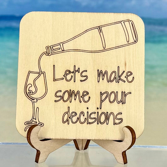 Laser-cut wooden fridge magnet engraved with the quote ‘Let’s make some pour decisions!’ and a pouring wine icon — handcrafted décor for wine lovers and humor seekers.