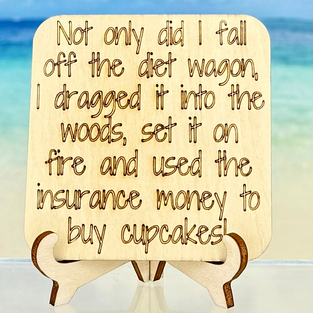 Laser-cut wooden fridge magnet engraved with the quote ‘Not only did I fall off the diet wagon—I dragged it into the woods, set it on fire and used the insurance money to buy cupcakes.’ — handcrafted humorous décor with strong magnet backing.