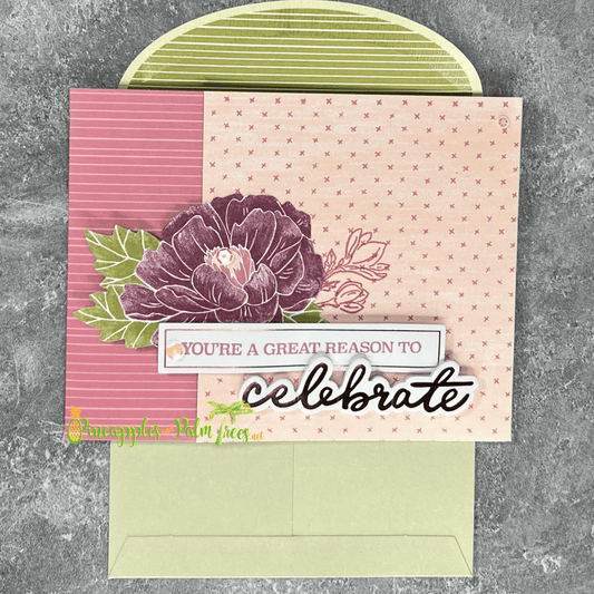 Celebratory greeting card “You’re a Great Reason to Celebrate” with purple flower illustration on the front.